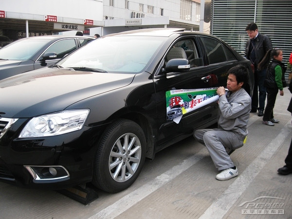 廣聯豐田工作人員為所有參加活動的車輛貼上統一的車標和側身貼